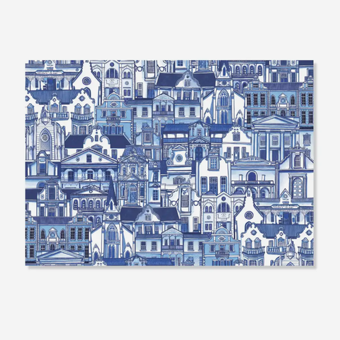 Paper placemats featuring an intricate blue and white architectural illustration of dense historic buildings, shown against a light gray background.