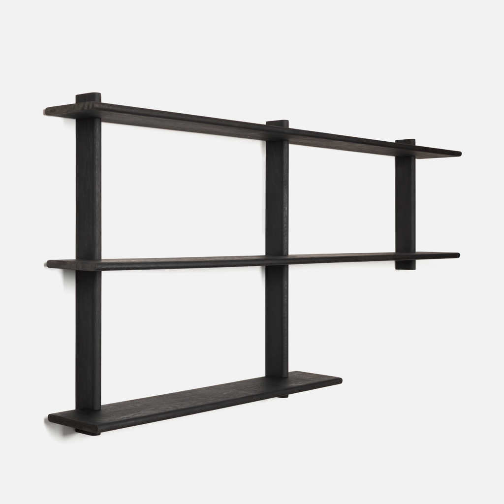 Black wall-mounted shelf with three shelves on a white background