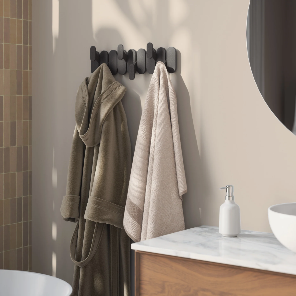Bathroom scene with towels hanging on a rack and a sink in the background